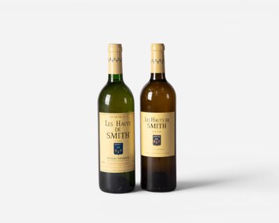 two bottles of wine sitting next to each other on a white surface