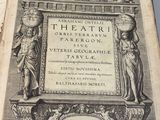 an old book with a picture of a statue on top of it