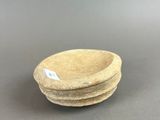a close up of a small bowl on a table