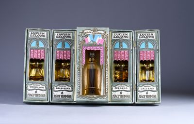 three boxes of perfumes are lined up on a table