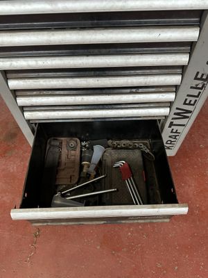 a tool box with tools inside of it on the floor