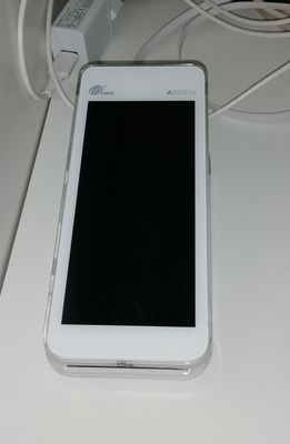 a white cell phone sitting on top of a table