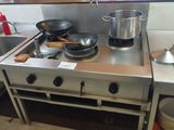 a stove with pots and pans on it in a kitchen