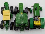 a green toy tractor and a yellow toy tractor