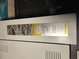 an image of a white refrigerator with a yellow label on it