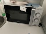 a microwave that is sitting on a counter in a kitchen