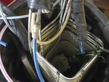 a person holding a bucket full of wires and wires