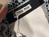 the back of a woman ' s dress with a label on it