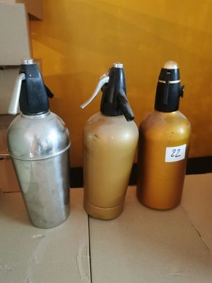 three bottles of liquid sitting next to each other on a table