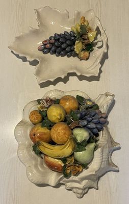 two bowls of fruit sitting on a table