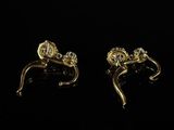 a pair of gold tone earrings with a flower design
