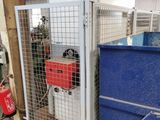 a metal cage with a gas can inside of it