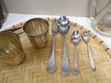 a tray with silver spoons and silverware on it