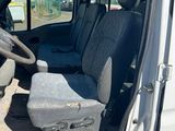 a white van with two seats and a steering wheel