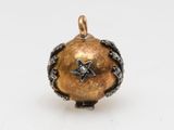 an image of a gold and silver pendant with a star on it