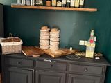 a small kitchen with a black refrigerator and a wooden counter