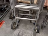 an image of a metal ladder with wheels in a warehouse