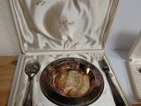 a silver plate and silverware in a box on a wooden table