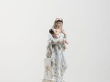 a figurine of a woman holding a baby