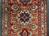 an old rug with fringes on a blue carpet