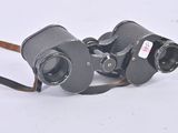 a pair of binoculars sitting on a white surface