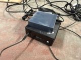 a black box sitting on top of a table next to a bunch of wires