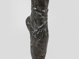 an image of a bronze sculpture of a woman ' s foot on a black base