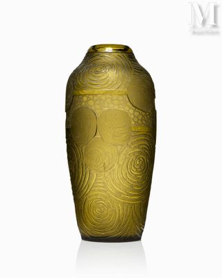 a gold vase that is sitting on a white surface