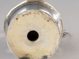 a silver vase with a hole in the middle of it