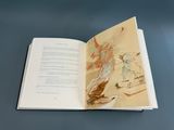 an open book with a picture of a woman and a cat