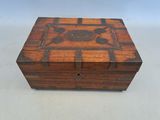 an old wooden box sitting on top of a white table