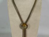 necklace made of metal and glass with a long brass chain