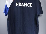 a t - shirt with the word france on it hanging on a hanger