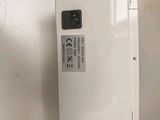 the back of a white box with a button on it