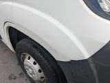 a close up of a white van parked on the side of the road