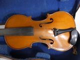 a violin that is sitting in a case on the floor