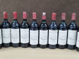 several bottles of wine are lined up on a table