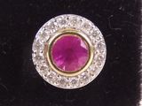 a close up of a ring with a pink stone surrounded by white diamonds