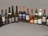 many bottles of wine lined up on a table