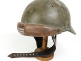helmet on a wooden base with a leather strap around the neck