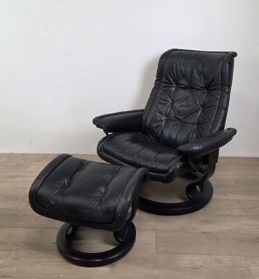 black leather reclining chair and ottoman with matching foot stool