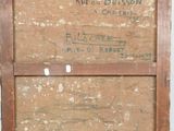 an old wooden box with writing on it sitting on top of a table