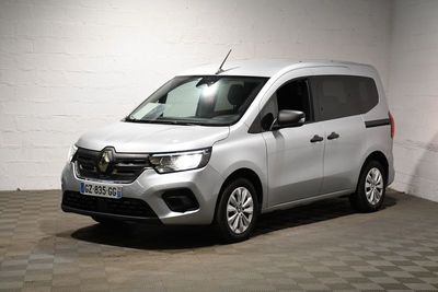 the white van is parked in a large room with checkered flooring