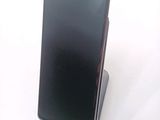 a cell phone that is sitting on top of a stand