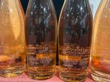 four bottles of wine are lined up on a table