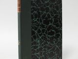 an old book with a green cover and a black cover