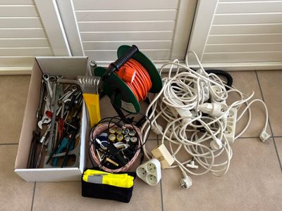 a box full of wires and tools on the floor