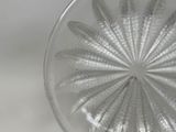 a close up of a glass plate with a flower design on it