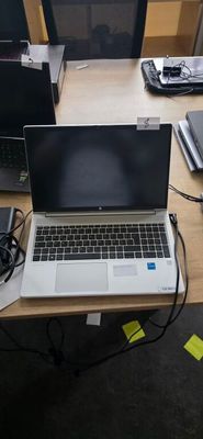 two laptops sitting on a desk next to each other