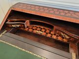 a wooden desk with a chess board on top of it